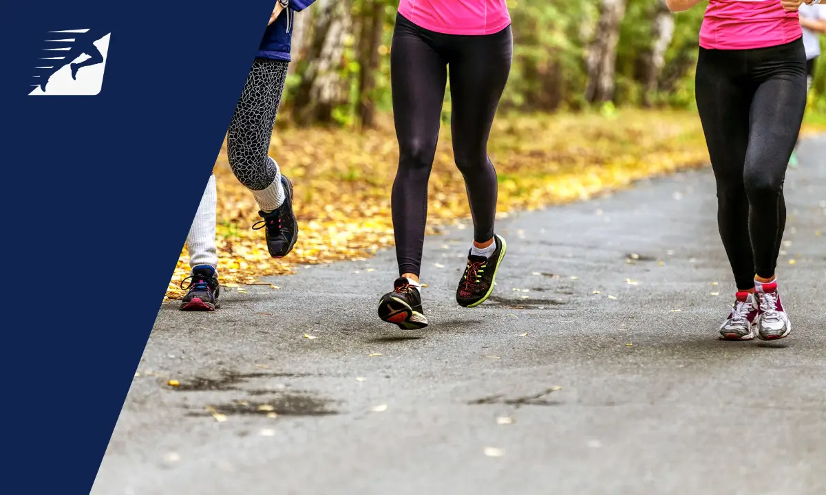 Die Beine einer Frau beim Laufen auf Asphalt