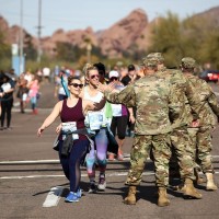 MILITARY APPRECIATION: A group of Military members line the 2019 Humana Rock &#039;n&#039; Roll Arizona Marathon &amp; ½ Marathon course encouraging runners as they pass by with race participants sharing their appreciation of the service members with a high-five (Photo