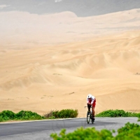 SANDS OF TIME:  Alistair Brownlee of Great Britain bikes in front of the coastal sand dunes during the bike portion of the 2018 Isuzu IRONMAN 70.3 World Championship Men (Photo by Donald Miralle/Getty Images for IRONMAN)
